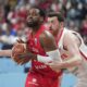 Poland's Jordan Loyd, left, and Turkey's Ercan Osmani in action during the Eurobasket, European Basketball Championship quarter final match between Turkey and Poland at the Riga Arena in Riga, Latvia, Tuesday, Sept. 9, 2025. (AP Photo/Sergei Grits)