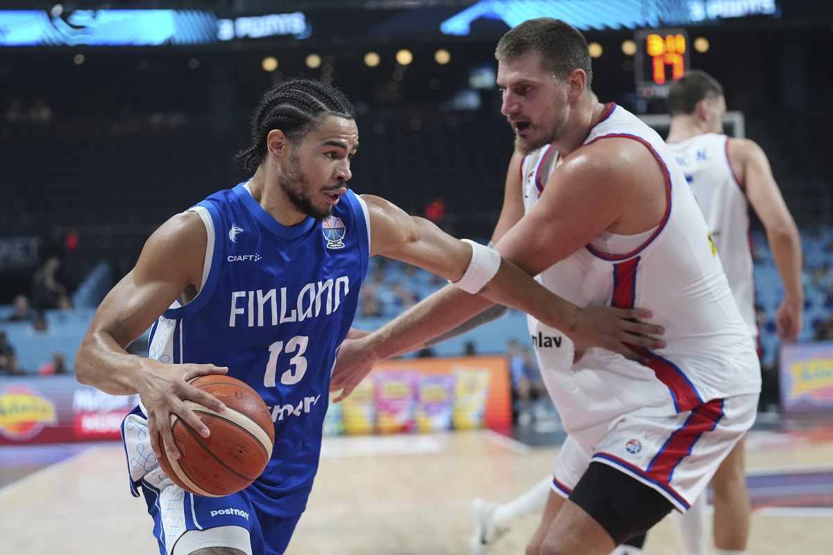 Finland's Olivier Nkamhoua, left, and Serbia's Nikola Jokic in action during the Eurobasket, European Basketball Championship round of 16 match between Serbia and Finland at the Riga Arena in Riga, Latvia, Saturday, Sept. 6, 2025. (AP Photo/Sergei Grits)