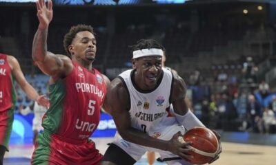 Germany's Isaac Bonga, right, and Portugal's Travante Williams in action during the Eurobasket, European Basketball Championship round of 16 match between Germany and Portugal at the Riga Arena in Riga, Latvia, Saturday, Sept. 6, 2025. (AP Photo/Sergei Grits)