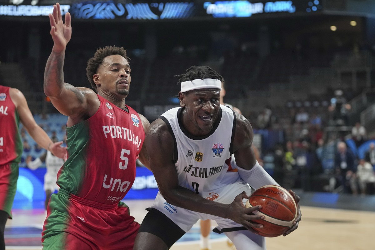 Germany's Isaac Bonga, right, and Portugal's Travante Williams in action during the Eurobasket, European Basketball Championship round of 16 match between Germany and Portugal at the Riga Arena in Riga, Latvia, Saturday, Sept. 6, 2025. (AP Photo/Sergei Grits)