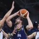 Greece's, Konstantinos Mitoglou, left, and Kostas Papanikolaou, right, defend against Bosnia's Jusuf Nurkic during the Eurobasket, European Basketball Championship Group C match between Greece and Bosnia at Spyros Kyprianou Arena, in Limassol, Cyprus, Tuesday, Sept. 2, 2025. (AP Photo/Chara Savvidou)