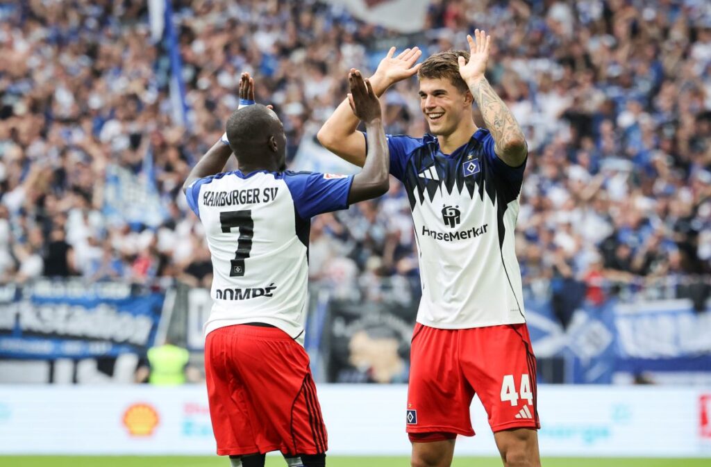 Hamburger SV's Luka Vuskovic, right, celebrates scoring their side's first goal of the game with Jean-Luc Dompe during the German Bundesliga soccer match between Hamburger SV and Heidenheim at Volksparkstadion in Hamburg, Germany, Saturday, Sept. 20, 2025. (Christian Charisius/dpa via AP)