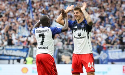 Hamburger SV's Luka Vuskovic, right, celebrates scoring their side's first goal of the game with Jean-Luc Dompe during the German Bundesliga soccer match between Hamburger SV and Heidenheim at Volksparkstadion in Hamburg, Germany, Saturday, Sept. 20, 2025. (Christian Charisius/dpa via AP)