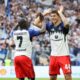 Hamburger SV's Luka Vuskovic, right, celebrates scoring their side's first goal of the game with Jean-Luc Dompe during the German Bundesliga soccer match between Hamburger SV and Heidenheim at Volksparkstadion in Hamburg, Germany, Saturday, Sept. 20, 2025. (Christian Charisius/dpa via AP)