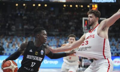 Germany's Dennis Schroder, left, drives to the basket as Turkey's Alperen Sengun tries to block him during the Eurobasket, European Basketball Championship final match between Turkey and Germany at the Riga Arena in Riga, Latvia, Sunday, Sept. 14, 2025. (AP Photo/Sergei Grits)