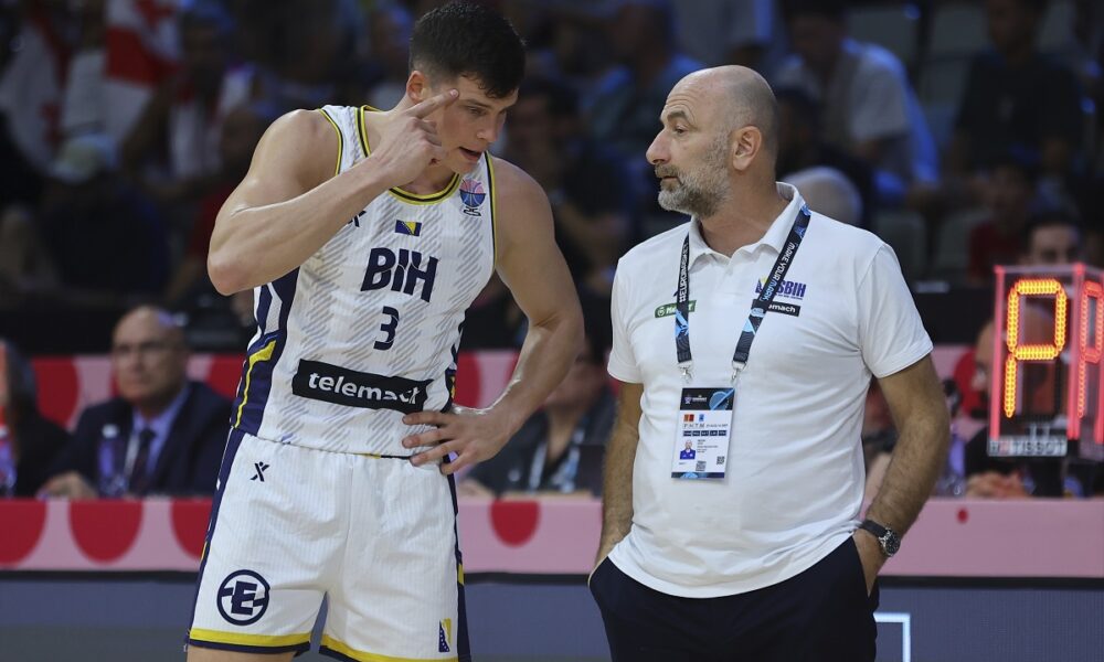 Bosnia's Amar Alibegovic, left, speaks with his coach Aziz Bekir during the Eurobasket, European Basketball Championship Group C match between Bosnia and Georgia at Spyros Kyprianou Arena, in Limassol, Cyprus, Thursday, Sept. 4, 2025. (AP Photo/Sakis Savvides)