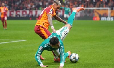 Galatasaray's Lucas Torreira, left, and Liverpool's Curtis Jones fight for the ball during the Champions League opening phase soccer match between Galatasaray and Liverpool at the Ali Sami Yen stadium, in Istanbul, Turkey, Tuesday, Sept. 30, 2025. (AP Photo/Francisco Seco)