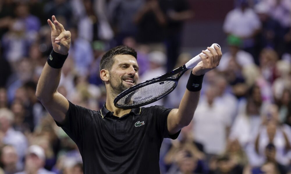Novak Djokovic, of Serbia, pretends to play the violin after defeating Jan-Lennard Struff, of Germany, during the fourth round of the US Open tennis championships, Sunday, Aug. 31, 2025, in New York. (AP Photo/Adam Hunger)