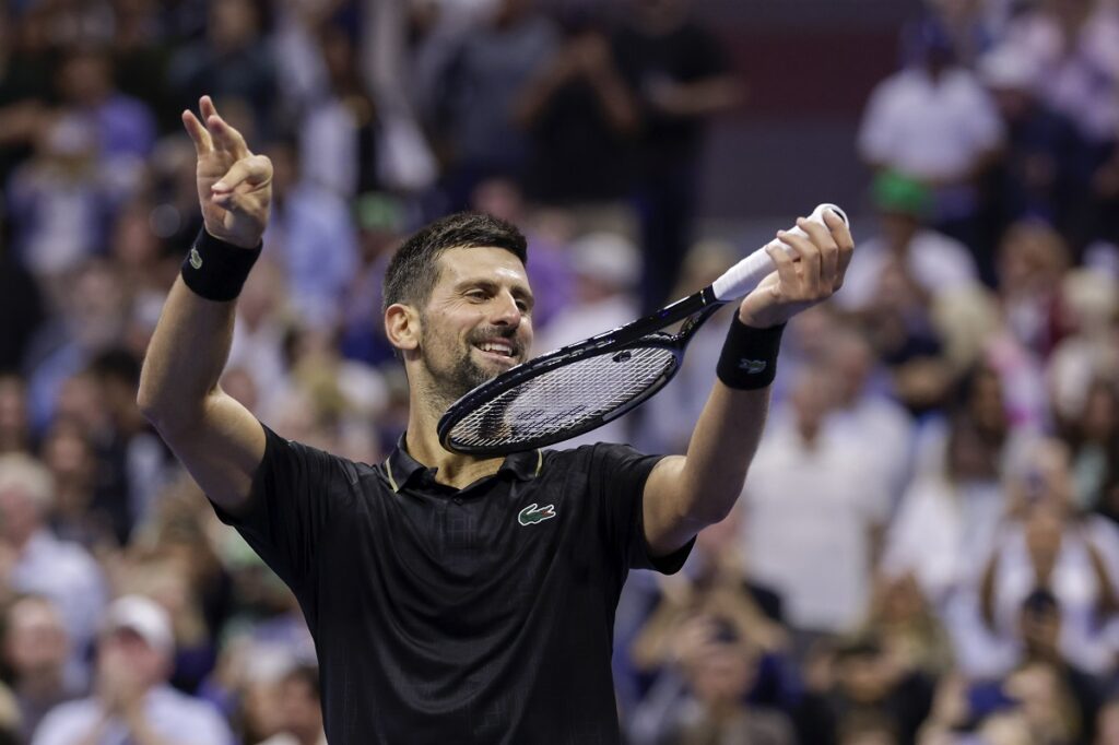 Novak Djokovic, of Serbia, pretends to play the violin after defeating Jan-Lennard Struff, of Germany, during the fourth round of the US Open tennis championships, Sunday, Aug. 31, 2025, in New York. (AP Photo/Adam Hunger)