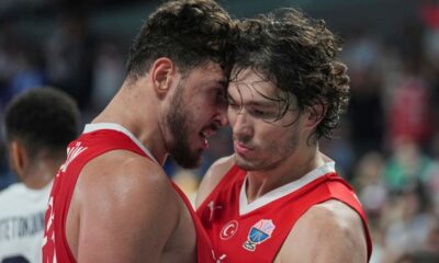 Turkey's Alperen Sengun, left, and Turkey's Cedi Osman celebrate after scoring during the Eurobasket, European Basketball Championship semi-final match between Greece and Turkey at the Riga Arena in Riga, Latvia, Friday, Sept. 12, 2025. (AP Photo/Sergei Grits)
