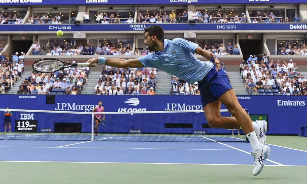 Novak Djokovic, of Serbia, returns a shot to Carlos Alcaraz, of Spain, during the men's singles semifinals of the U.S. Open tennis championships, Friday, Sept. 5, 2025, in New York. (AP Photo/Yuki Iwamura)