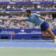 Novak Djokovic, of Serbia, returns a shot to Carlos Alcaraz, of Spain, during the men's singles semifinals of the U.S. Open tennis championships, Friday, Sept. 5, 2025, in New York. (AP Photo/Yuki Iwamura)
