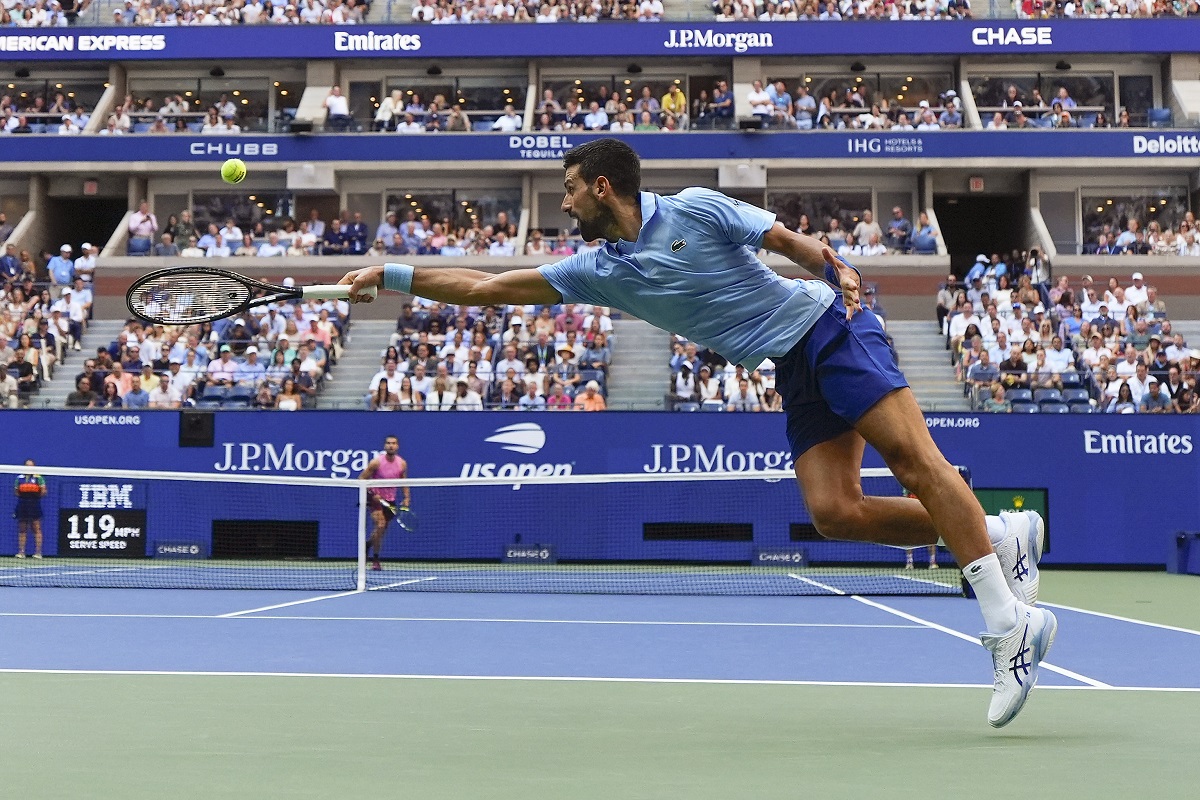 Novak Djokovic, of Serbia, returns a shot to Carlos Alcaraz, of Spain, during the men's singles semifinals of the U.S. Open tennis championships, Friday, Sept. 5, 2025, in New York. (AP Photo/Yuki Iwamura)