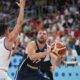 Slovenia's Luka Doncic, centre, tries to shoot while defended by Italy's Simone Fontecchio during the Eurobasket, European Basketball Championship round of 16 match between Italy and Slovenia at the Riga Arena in Riga, Latvia, Sunday, Sept. 7, 2025. (AP Photo/Sergei Grits)
