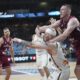 Latvia's Rolands Smits, right, challenges for the ball with Lithuania's Arnas Velicka during the Eurobasket, European Basketball Championship round of 16 match between Lithuania and Latvia at the Riga Arena in Riga, Latvia, Saturday, Sept. 6, 2025. (AP Photo/Sergei Grits)