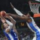 Finland's Lauri Markkanen, centre, tries to shoot while defended by Greece's Kostas Antetokounmpo during the Eurobasket, European Basketball Championship third place match between Greece and Finland at the Riga Arena in Riga, Latvia, Sunday, Sept. 14, 2025. (AP Photo/Sergei Grits)