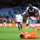 Bologna's goalkeeper Lukasz Skorupski makes a save in front of Aston Villa's Evann Guessand during the Europa League soccer match between Aston Villa and Bologna at Villa Park stadium in Birmingham, England, Thursday, Sept. 25, 2025. (AP Photo/Darren Staples)