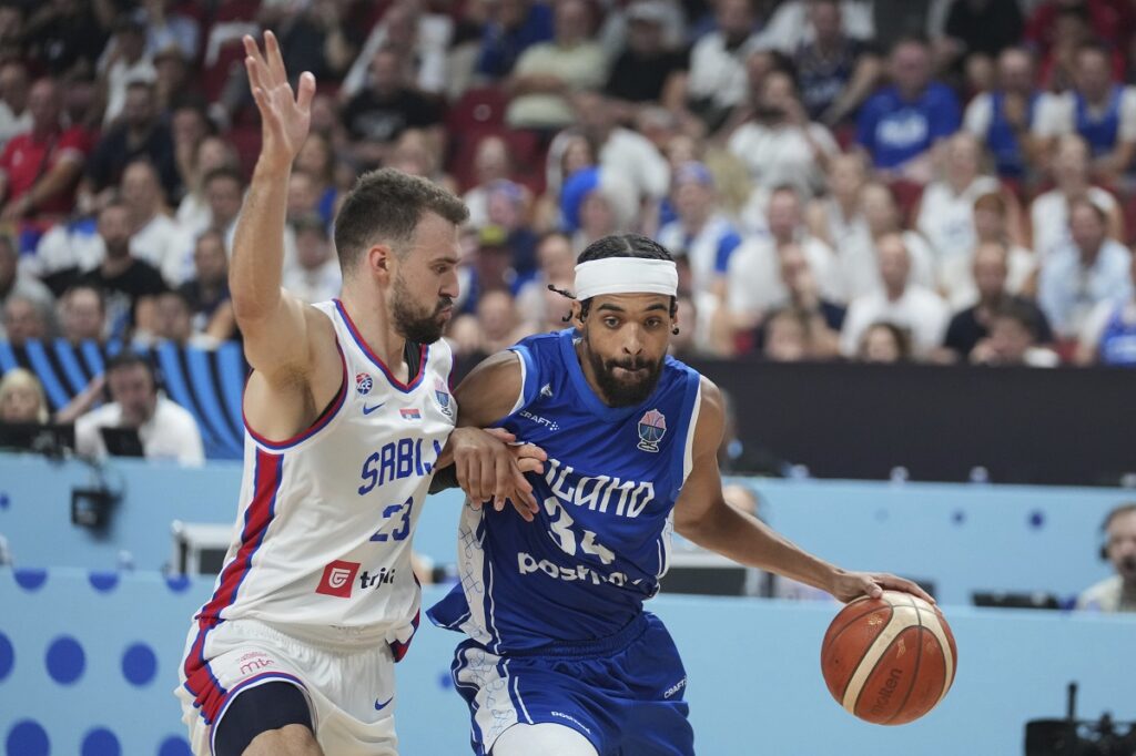 Serbia's Marko Guduric, left, and Finland's Jacob Grandison in action during the Eurobasket, European Basketball Championship round of 16 match between Serbia and Finland at the Riga Arena in Riga, Latvia, Saturday, Sept. 6, 2025. (AP Photo/Sergei Grits)