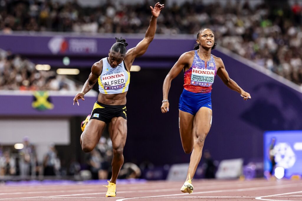 Melissa Jefferson-Wooden of the U.S., right, competes to win ahead of third placed Julien Alfred of Saint Lucia,, in the women's 100 meters final, at the World Athletics Championships in Tokyo, Sunday, Sept. 14, 2025. (Michael Buholzer, Keystone via AP)