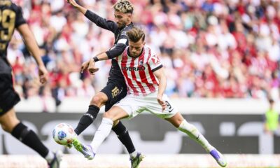 Stuttgart's Atakan Karazor, left, and Freiburg's Lucas Höler, right, challenge for the ball during the Bundesliga soccer match between SC Freiburg and VfB Stuttgart in Freiburg, Germany, Saturday, Sept. 13, 2025. (Tom Weller/dpa via AP)