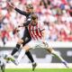 Stuttgart's Atakan Karazor, left, and Freiburg's Lucas Höler, right, challenge for the ball during the Bundesliga soccer match between SC Freiburg and VfB Stuttgart in Freiburg, Germany, Saturday, Sept. 13, 2025. (Tom Weller/dpa via AP)