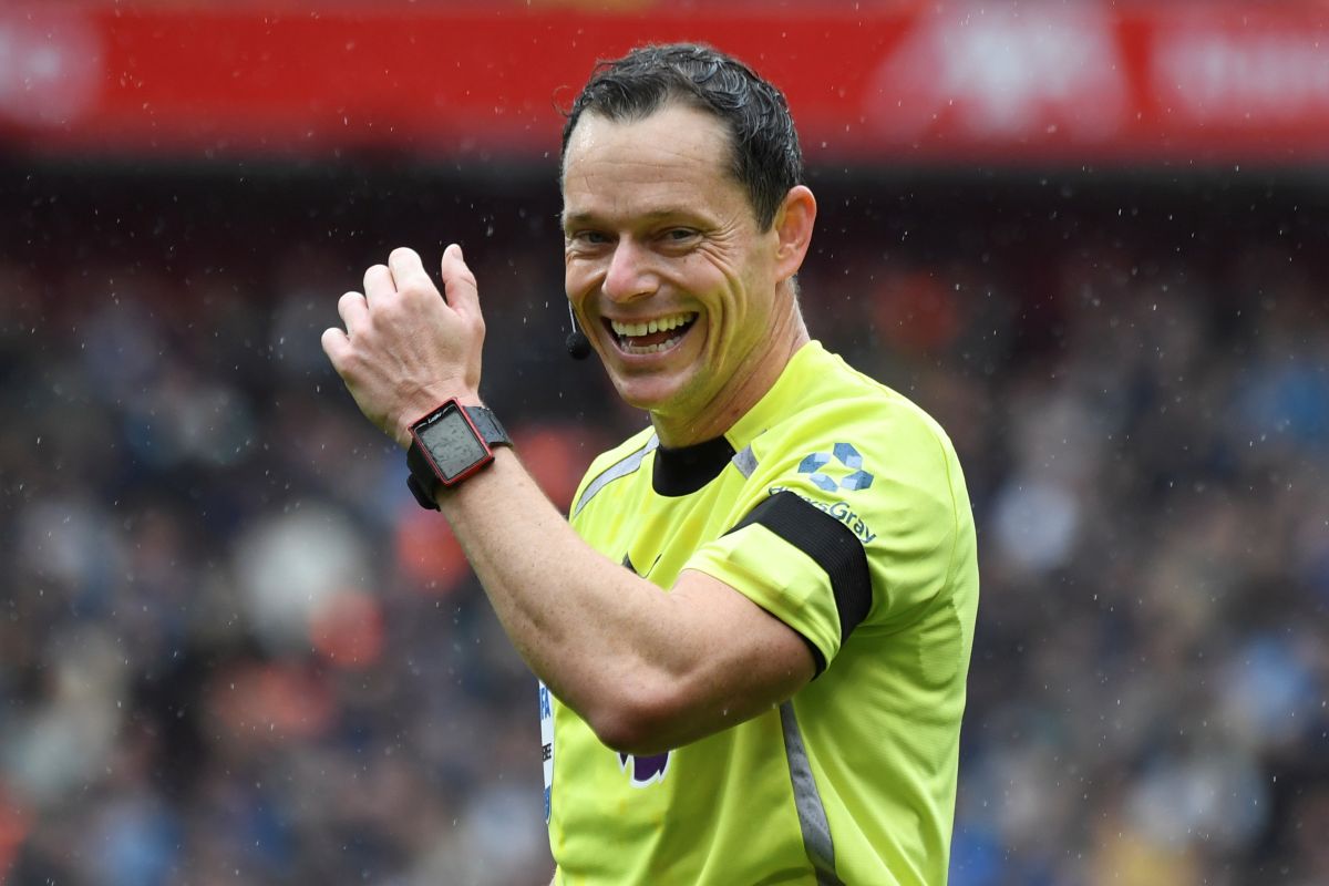 Referee Darren England smiles during the English Premier League soccer match between Liverpool and Everton at Anfield stadium in Liverpool, England, Saturday, Sept. 20, 2025. (AP Photo/Rui Vieira)