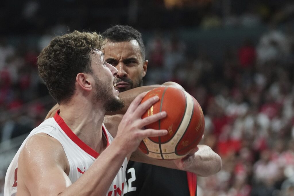 Turkey's Alperen Sengun, front, tries to score as Germany's Johannes Thiemann blocks him during the Eurobasket, European Basketball Championship final match between Turkey and Germany at the Riga Arena in Riga, Latvia, Sunday, Sept. 14, 2025. (AP Photo/Sergei Grits)