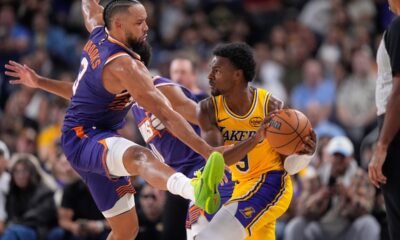 Los Angeles Lakers guard Bronny James, right, tries to pass while under pressure from Phoenix Suns forward Dillon Brooks during the second half of an NBA preseason basketball game Friday, Oct. 3, 2025, in Palm Desert, Calif. (AP Photo/Mark J. Terrill)