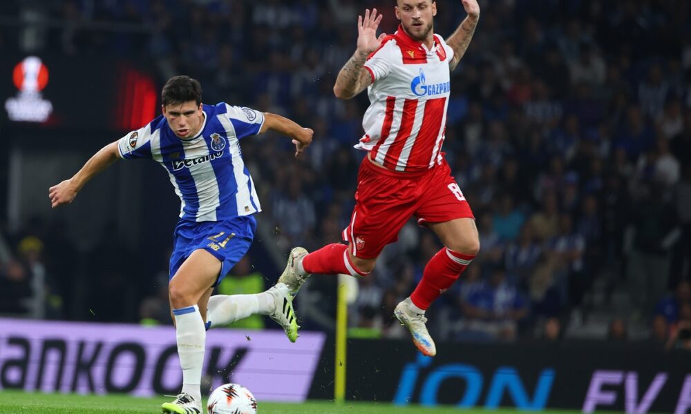 Porto's Dominik Prpic runs with the ball past Red Star's Marko Arnautovic, right, during the Europa League opening phase soccer match between FC Porto and Red Star Belgrade at the Dragao stadium in Porto, Portugal, Thursday, Oct. 2, 2025. (AP Photo/Luis Vieira)