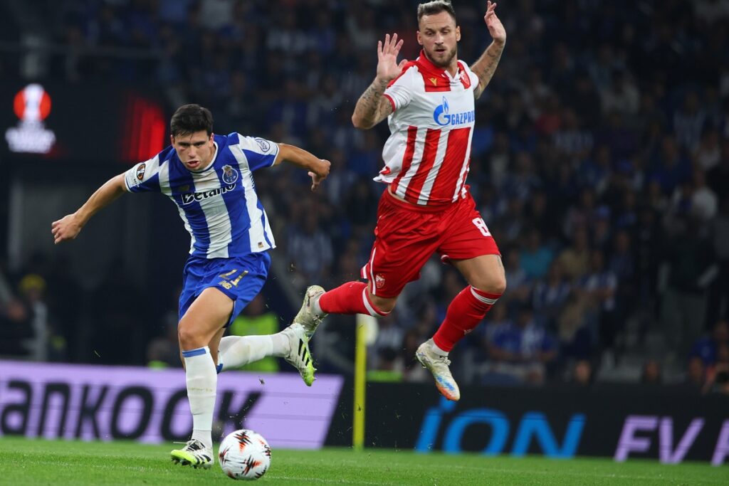 Porto's Dominik Prpic runs with the ball past Red Star's Marko Arnautovic, right, during the Europa League opening phase soccer match between FC Porto and Red Star Belgrade at the Dragao stadium in Porto, Portugal, Thursday, Oct. 2, 2025. (AP Photo/Luis Vieira)