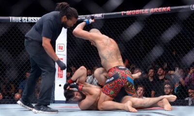 Alex Pereira, right, of Brazil, hits UFC light heavyweight champion Magomed Ankalaev, of Russia, as the referee looks on during the UFC 320 mixed martial arts bout Saturday, Oct. 4, 2025, in Las Vegas. (Steve Marcus/Las Vegas Sun via AP)