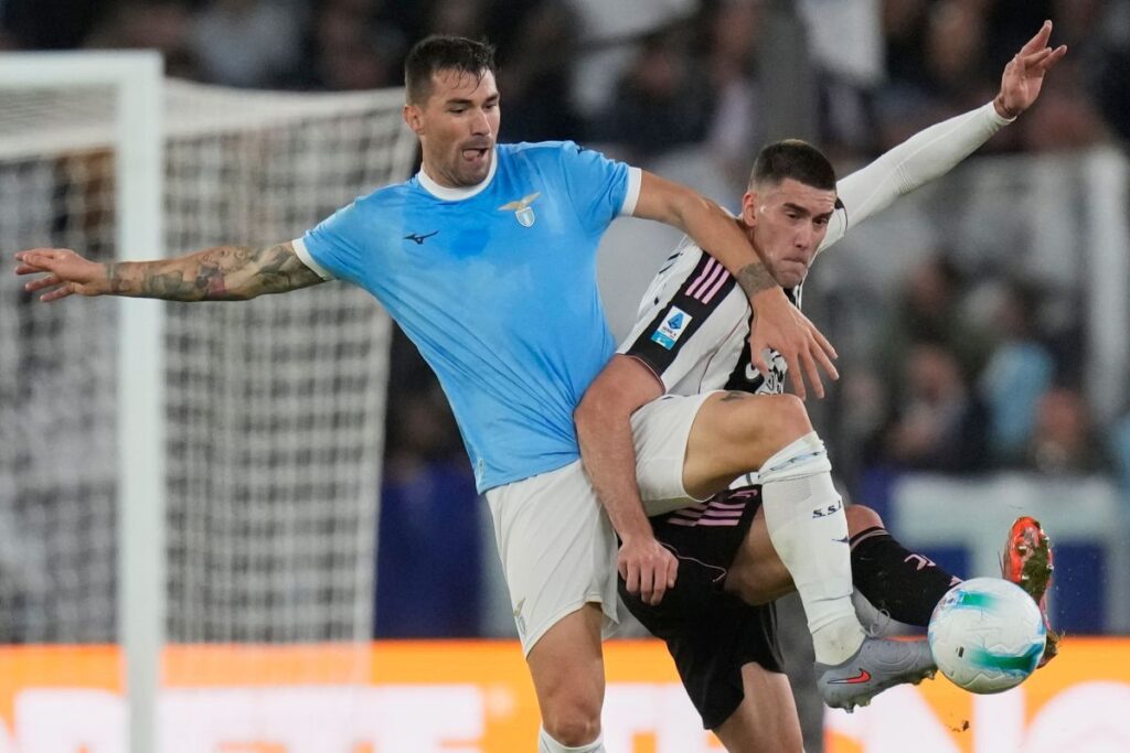 Lazio's Alessio Romagnoli, left, and ju9- fight for the ball during the Italian Serie A soccer match between Lazio and Juventus in Rome, Sunday, Oct. 26, 2025. (AP Photo/Gregorio Borgia)