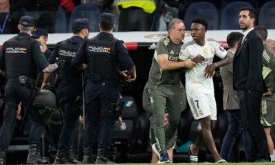 Real Madrid's Vinicius Junior is restrained by coaching staff duringa post match scuffle at La Liga soccer match between Real Madrid and Barcelona in Madrid, Spain, Sunday, Oct. 26, 2025. (AP Photo/Bernat Armangue)
