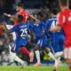 Chelsea's Moises Caicedo vies for the ball with Benfica's Vangelis Pavlidis, left, during a Champions League opening phase soccer match between Chelsea and SL Benfica at Stamford Bridge stadium in London, Tuesday, Sept. 30, 2025. (AP Photo/Kin Cheung)
