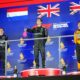 First position winner Mercedes driver George Russell of Britain, center, celebrates on the podium with second place winner Red Bull driver Max Verstappen of the Netherlands, left, and third position winner McLaren driver Lando Norris of Britain during the Singapore Formula One Grand Prix at the Marina Bay Street Circuit in Singapore, Sunday, Oct. 5, 2025. (AP Photo/Vincent Thian)