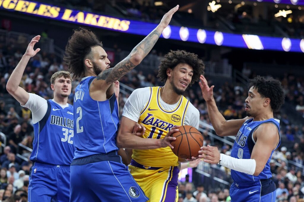 Los Angeles Lakers center Jaxson Hayes (11) secures a rebound against Dallas Mavericks center Dereck Lively II (2) and guard Ryan Nembhard (9) during the first half of a preseason NBA basketball game Wednesday, Oct. 15, 2025, in Las Vegas. (AP Photo/Ian Maule)