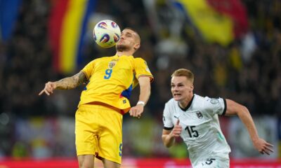 Romania's Daniel Birligea controls the ball next to Austria's Philipp Lienhart during the World Cup 2026 group H qualifying soccer match between Romania and Austria at the National Arena stadium, in Bucharest, Romania, Sunday, Oct. 12, 2025. (AP Photo/Andreea Alexandru)