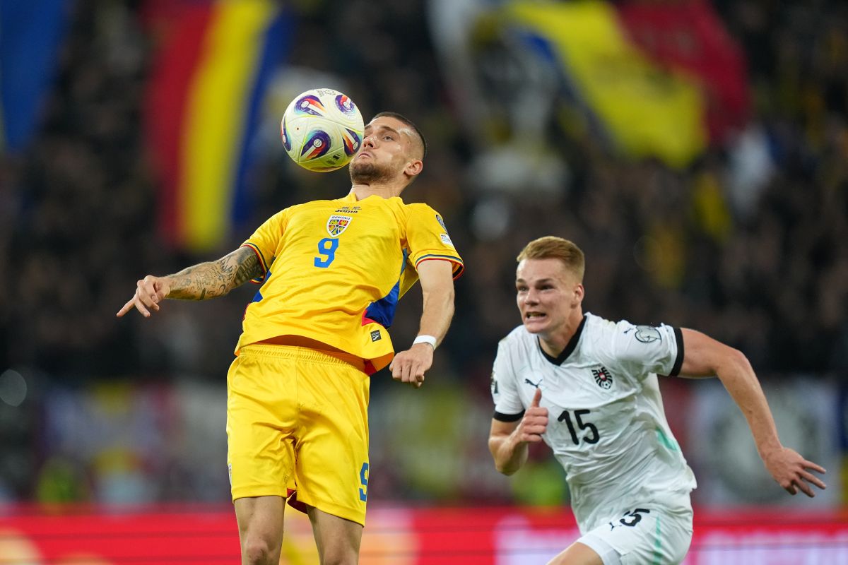 Romania's Daniel Birligea controls the ball next to Austria's Philipp Lienhart during the World Cup 2026 group H qualifying soccer match between Romania and Austria at the National Arena stadium, in Bucharest, Romania, Sunday, Oct. 12, 2025. (AP Photo/Andreea Alexandru)