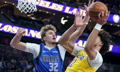 Dallas Mavericks forward Cooper Flagg (32) blocks a shot from Los Angeles Lakers center Jaxson Hayes (11) during the first half of a preseason NBA basketball game Wednesday, Oct. 15, 2025, in Las Vegas. (AP Photo/Ian Maule)
