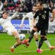 Moenchengladbach's Philipp Sander, left, blocks the shot by Bayern's Harry Kane during the German Bundesliga soccer match between Borussia Moenchengladbach and Bayern Munich in Moenchengladbach, Germany, Saturday, Oct. 25, 2025. (AP Photo/Martin Meissner)