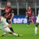 Pisa's Antonio Caracciolo tackles AC Milan's Strahinja Pavlovic during the Serie A soccer match between AC Milan and Pisa in Milan, Italy, Friday, Oct. 24, 2025. (AP Photo/Antonio Calanni)