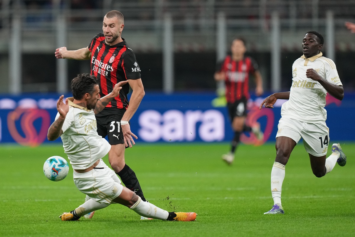 Pisa's Antonio Caracciolo tackles AC Milan's Strahinja Pavlovic during the Serie A soccer match between AC Milan and Pisa in Milan, Italy, Friday, Oct. 24, 2025. (AP Photo/Antonio Calanni)