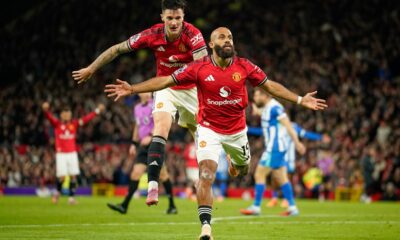 Manchester United's Bryan Mbeumo, front, celebrates with Benjamin Sesko after scoring his side's third goal during the English Premier League soccer match between Manchester United and Brighton & Hove Albion in Manchester, England, Saturday, Oct. 25, 2025. (AP Photo/Dave Thompson)