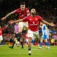 Manchester United's Bryan Mbeumo, front, celebrates with Benjamin Sesko after scoring his side's third goal during the English Premier League soccer match between Manchester United and Brighton & Hove Albion in Manchester, England, Saturday, Oct. 25, 2025. (AP Photo/Dave Thompson)