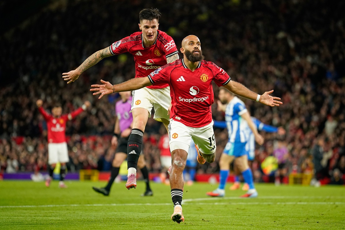 Manchester United's Bryan Mbeumo, front, celebrates with Benjamin Sesko after scoring his side's third goal during the English Premier League soccer match between Manchester United and Brighton & Hove Albion in Manchester, England, Saturday, Oct. 25, 2025. (AP Photo/Dave Thompson)