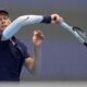 Jannik Sinner of Italy returns a shot to Learner Tien of the United States in the men's singles final match for the China Open tennis tournament in Beijing on Wednesday, Oct. 1, 2025. (AP Photo/Mahesh Kumar A.)