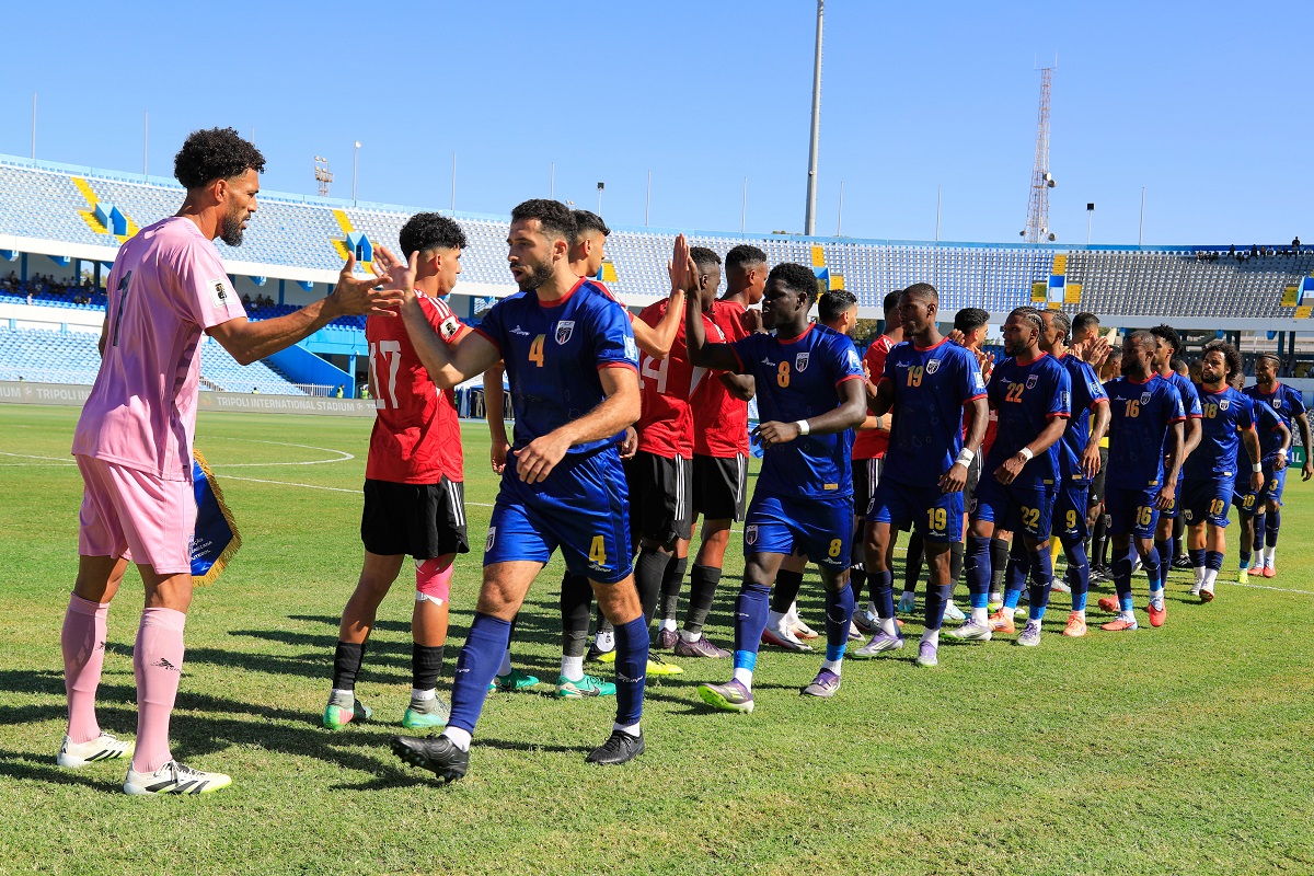 Cape Verde, right, players greet Libyan players before their World Cup 2026 African qualifier Group D soccer match in Tripoli, Libya, Wednesday, Oct. 8, 2025. (AP Photo/Yousef Murad)