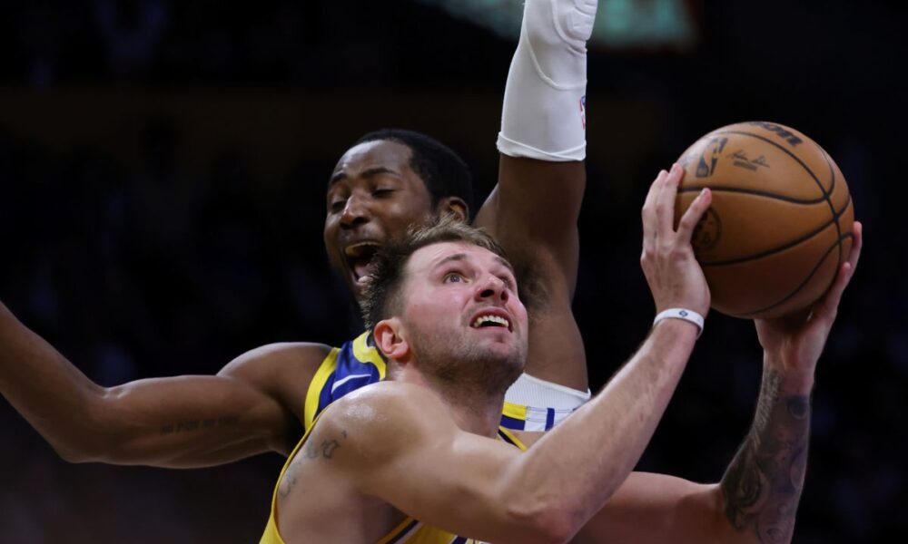 Los Angeles Lakers guard Luka Doncic (77) attempts a shot against the Golden State Warriors during the second half of an NBA basketball game Tuesday, Oct. 21, 2025, in Los Angeles. (AP Photo/Ethan Swope)