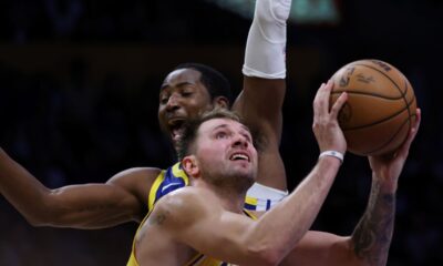 Los Angeles Lakers guard Luka Doncic (77) attempts a shot against the Golden State Warriors during the second half of an NBA basketball game Tuesday, Oct. 21, 2025, in Los Angeles. (AP Photo/Ethan Swope)