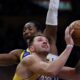 Los Angeles Lakers guard Luka Doncic (77) attempts a shot against the Golden State Warriors during the second half of an NBA basketball game Tuesday, Oct. 21, 2025, in Los Angeles. (AP Photo/Ethan Swope)